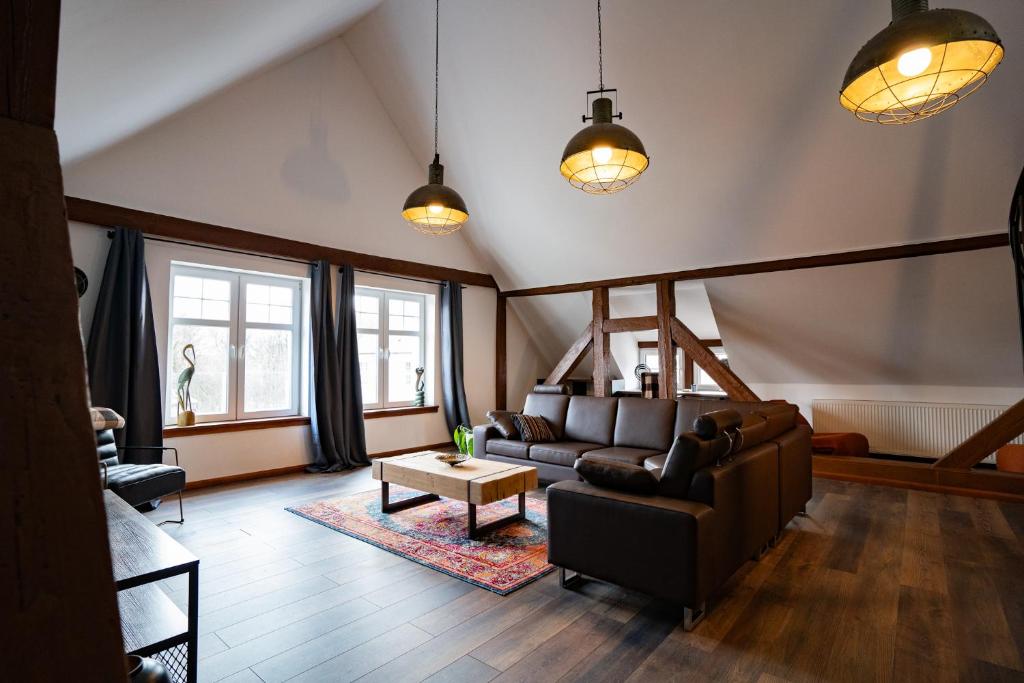 a living room with a couch and a table at Apartament Loftowy Ordona 5 in Szczecinek