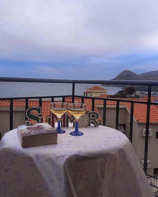 a table with a cake on top of a balcony at Vista del Mare Rooms 1 in Agios Ioannis Kaspaka