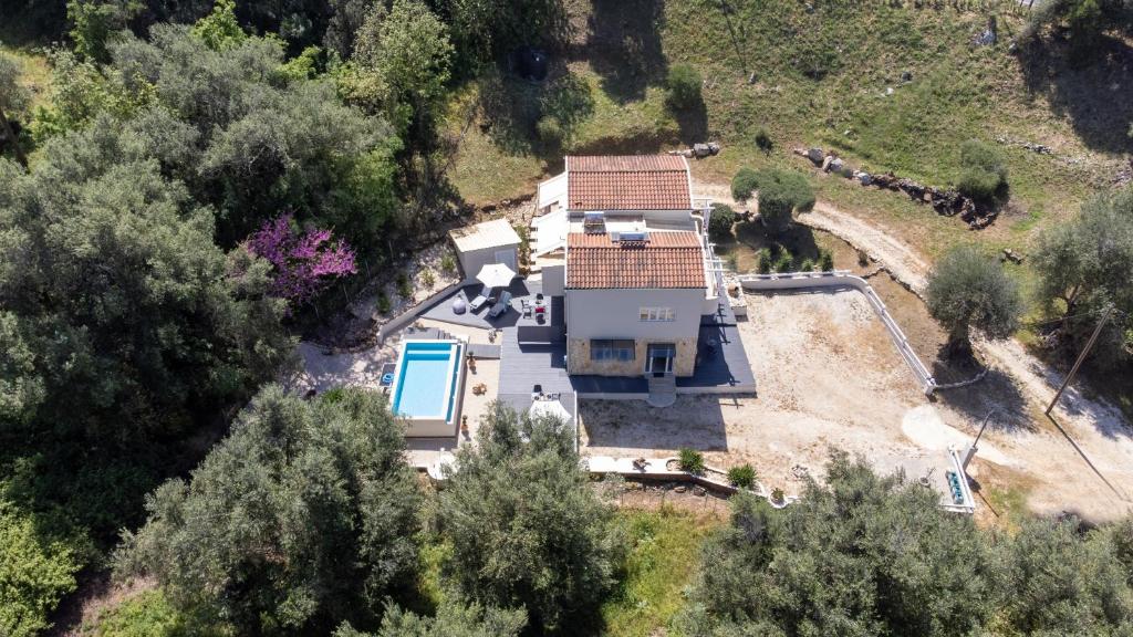 an aerial view of a house with a pool at Armoniahousesuites in Perítheia