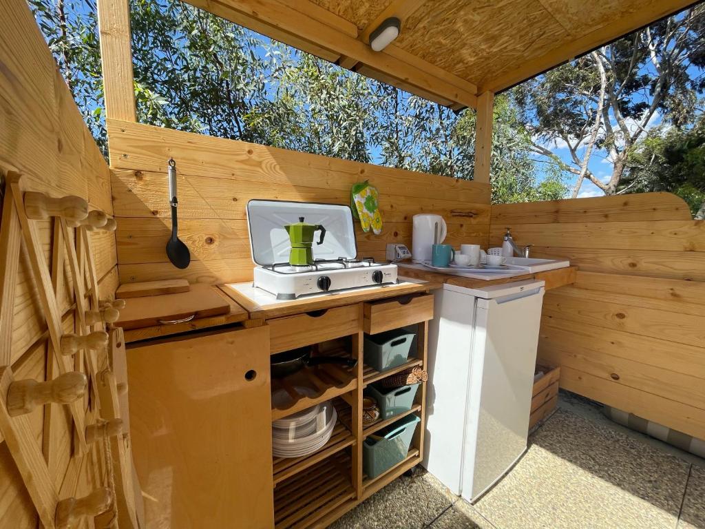 an outdoor kitchen with a sink and a stove at Lavender Glamping in Elmas