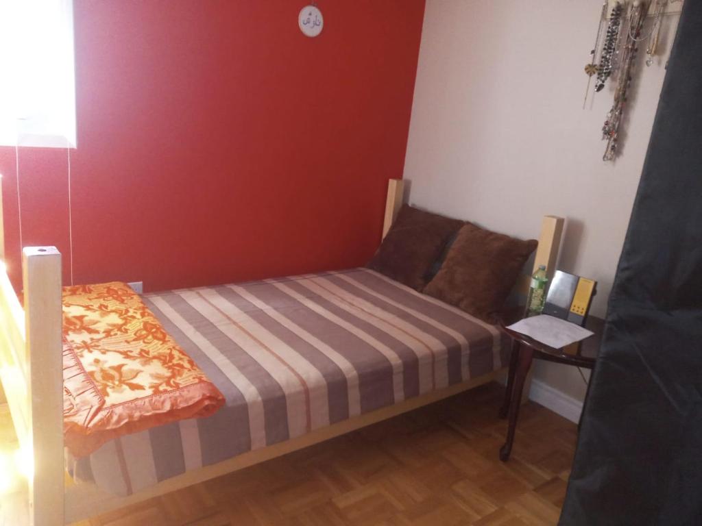 a small bedroom with a bed and a table at ROOM for Rent in Mississauga
