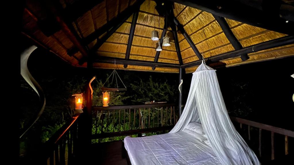 a hammock in a room with a roof at Kruger Kumba - Mugwenzi in Marloth Park