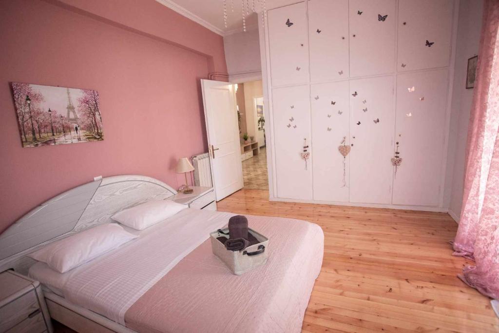 a bedroom with a white bed and a wall with butterflies at Casa di Michele in Perama