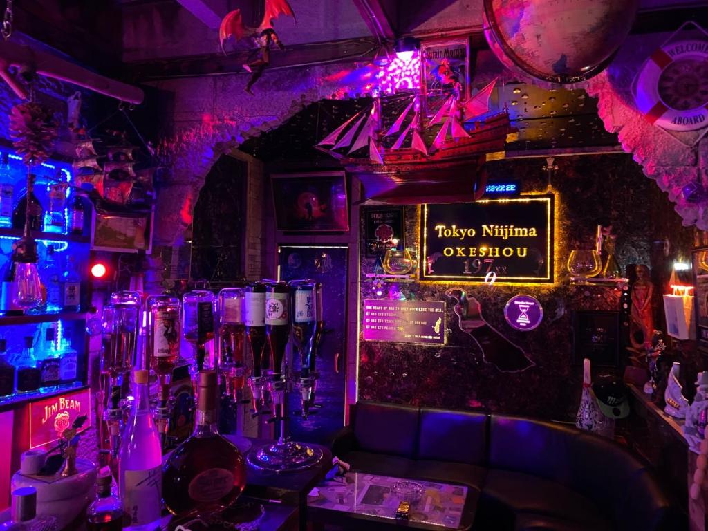 eine Bar mit violetten Lichtern und ein Schild, das fröhliche Ninja-Operatoren liest in der Unterkunft OKESYOU - Vacation STAY 43545v in Niijimamura