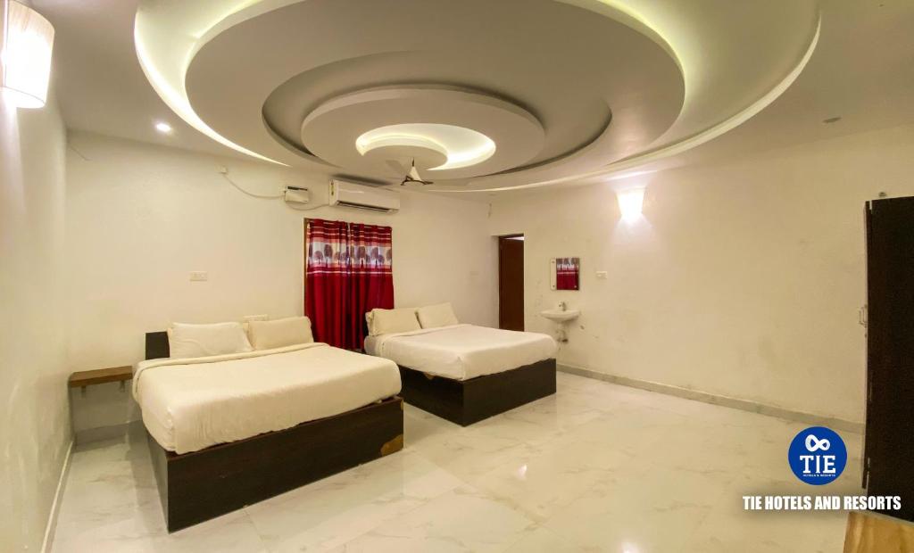 a room with two beds and a circular ceiling at La Paradise Luxury in Puducherry