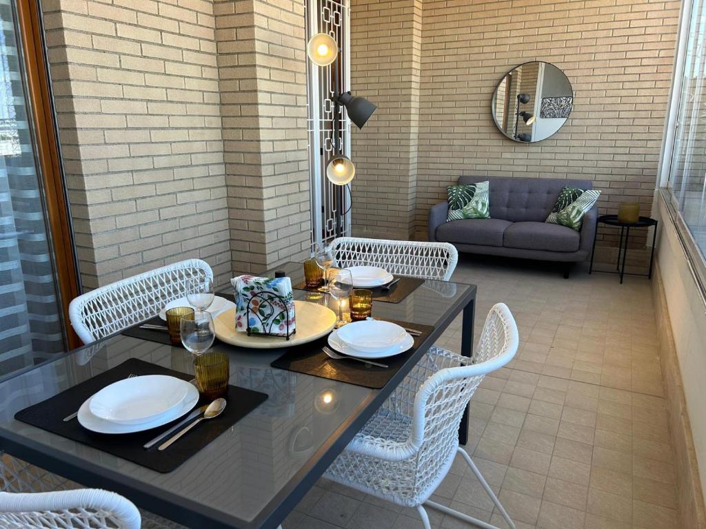 a table and chairs in a patio with a couch at Miro Home II in Rome