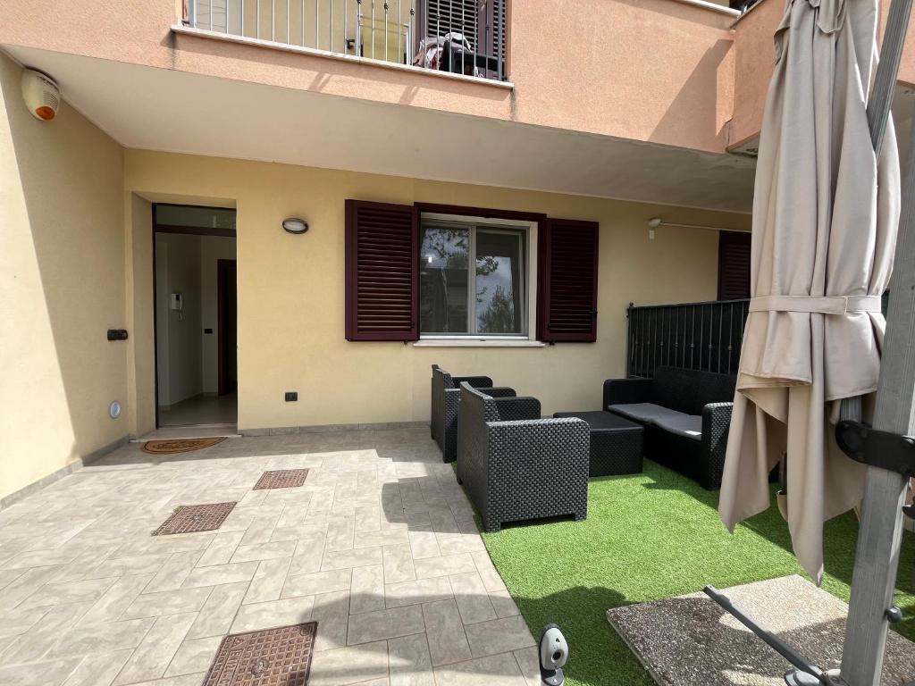 a living room with a couch and a patio at Azzurro Horizon Apartment in Bellaria-Igea Marina