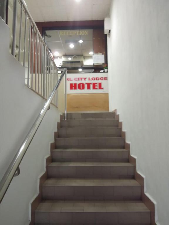 a flight of stairs in a building with a hotel sign at KL CITY LODGE in Kuala Lumpur