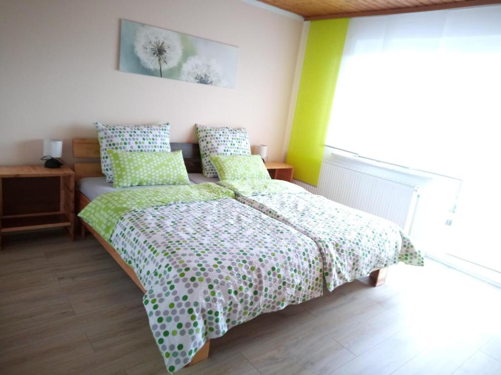 a bedroom with two beds with green and white sheets at Ferienwohnung Rackl in Furth im Wald