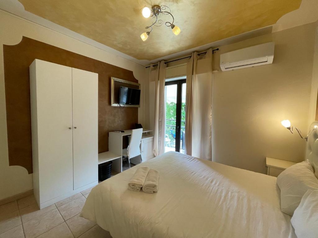 Postel nebo postele na pokoji v ubytování Hotel Central Giacomini