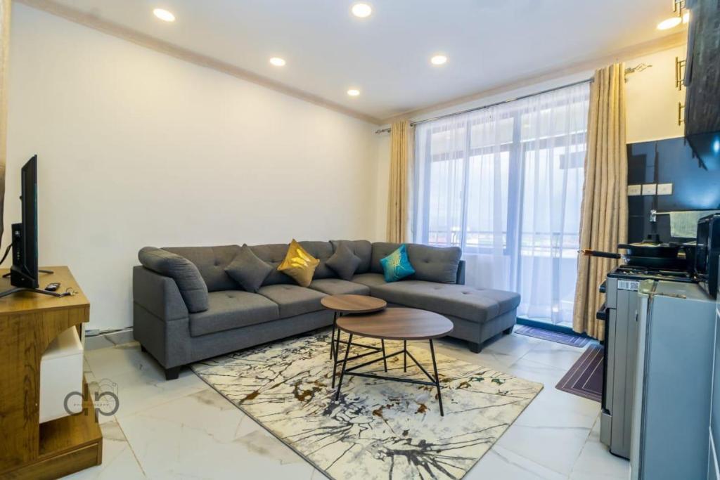 a living room with a couch and a table at DANMIC HOMES AND BNB in Mombasa