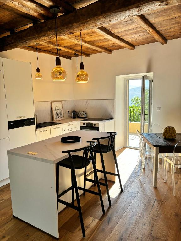 une cuisine avec des appareils blancs et une table avec des chaises dans l'établissement CASA SAN MATTEU, à Patrimonio