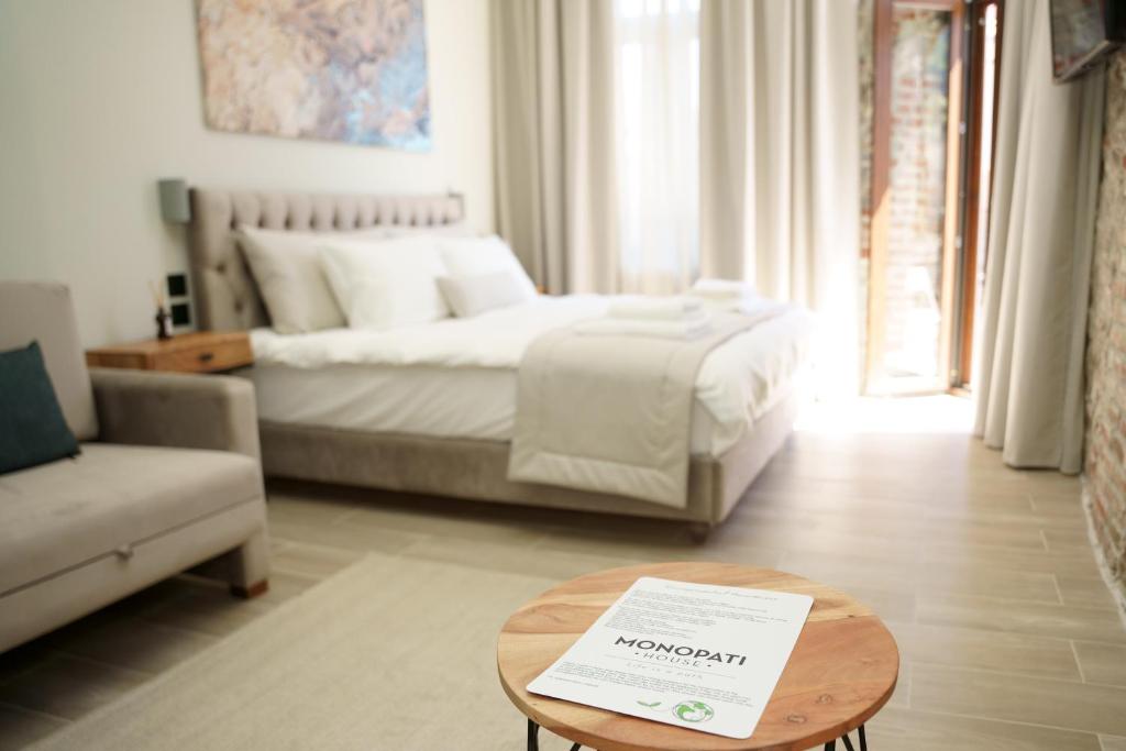 a bedroom with a bed and a table with a sign on it at MONOPATI HOUSE in Mouzaki