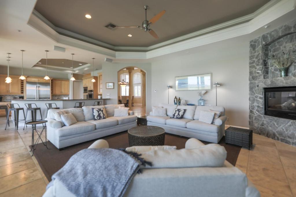 Royal Palm House في كابتيفا: غرفة معيشة مع كنبتين ومدفأة