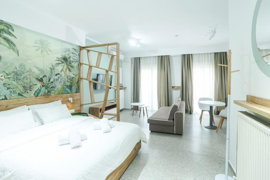 a bedroom with a large white bed and a large painting at the 203 in Giannitsa