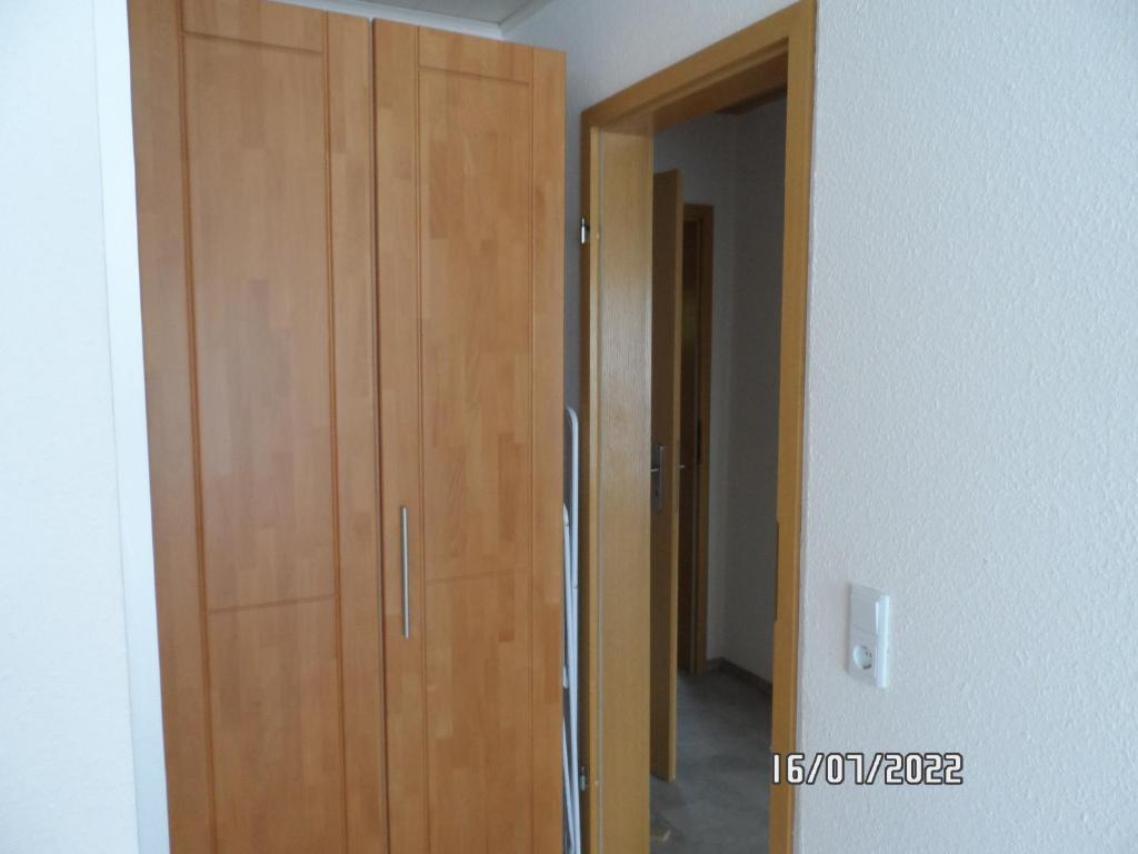 a wooden cabinet in a room with a hallway at Bichlhof Bärfra Ferienwohnung Hunsrück in Morbach