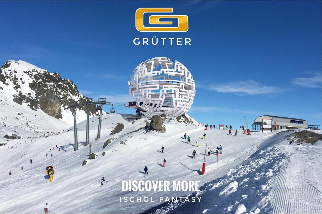 un grupo de personas esquiando por una pista cubierta de nieve en Grütter Luxury Apartments, en Ischgl