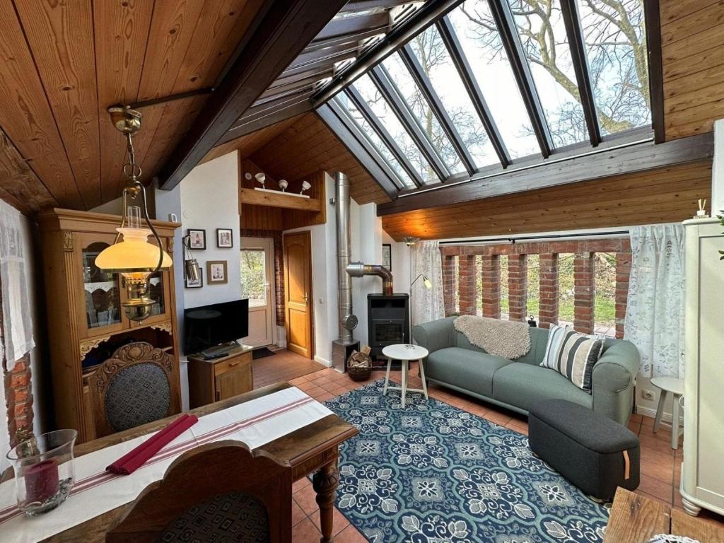 a living room with a couch and a glass ceiling at Landhaus up de Warft - Backhaus in Werdum