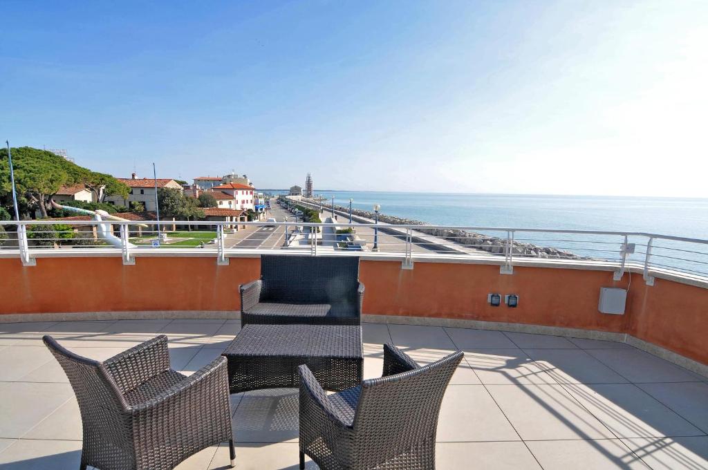 a balcony with chairs and a view of the ocean at Bellavista in Caorle