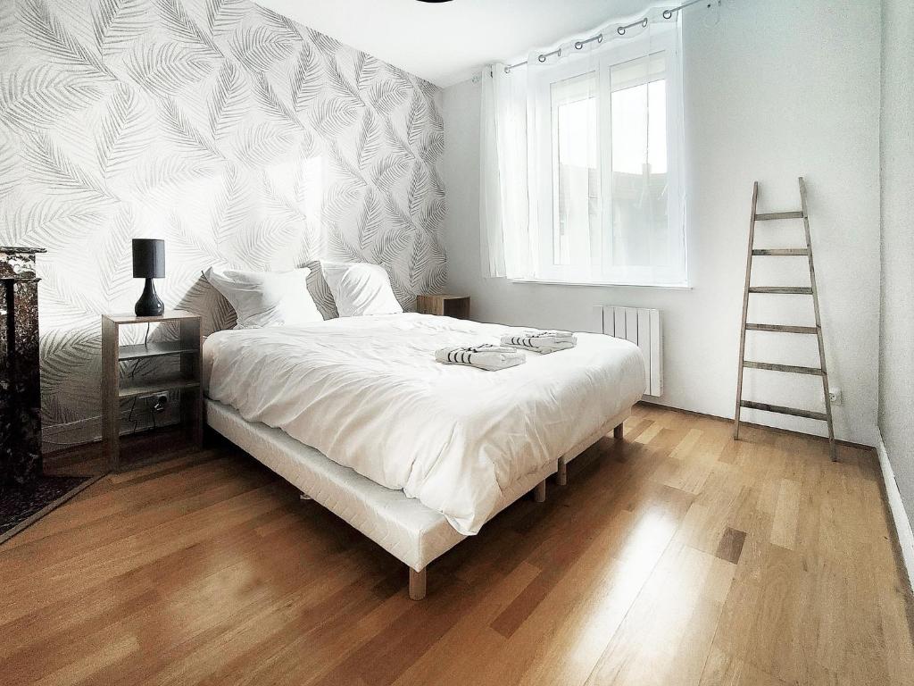 Säng eller sängar i ett rum på Appartement cosy rethel