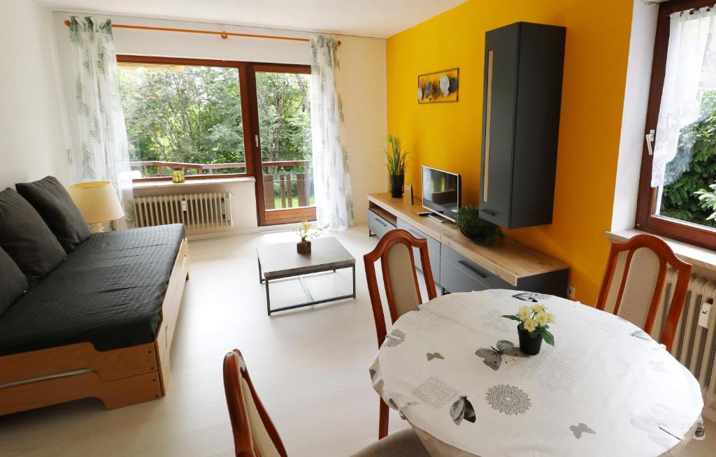 a living room with a table and a couch at Fewo Sunneschii, Höchenschwand, Dorf am Himmel, Sauna im Haus in Höchenschwand