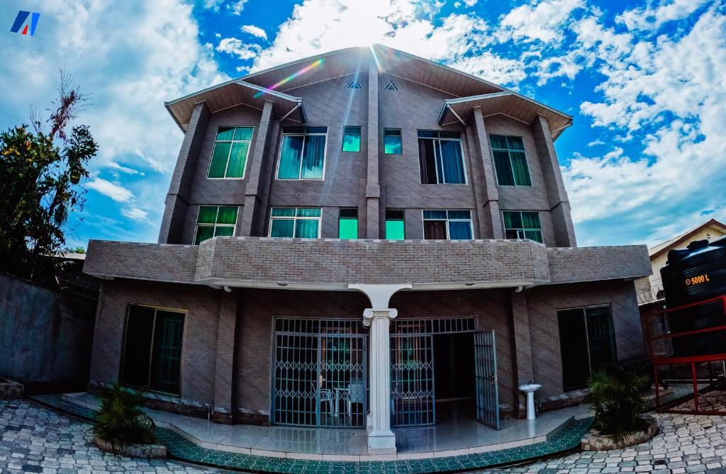 a building with green windows on top of it at Sunshine Residence in Bujumbura
