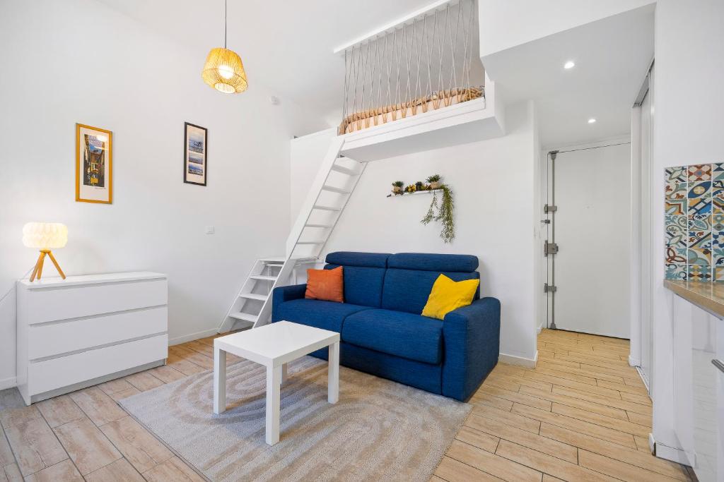 un salon avec un canapé bleu et une table dans l'établissement Nice Renting - GAUTIER - Elegance Height Port & Castle Nice, à Nice