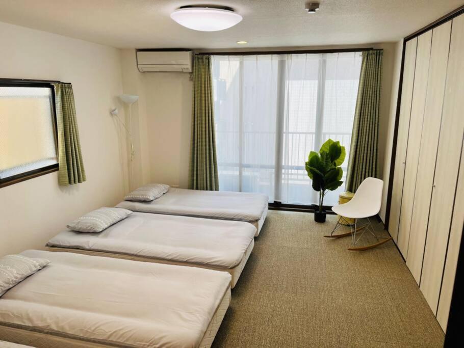 Postel nebo postele na pokoji v ubytování N's Home-南名古屋駅一軒家ルームシェア-4
