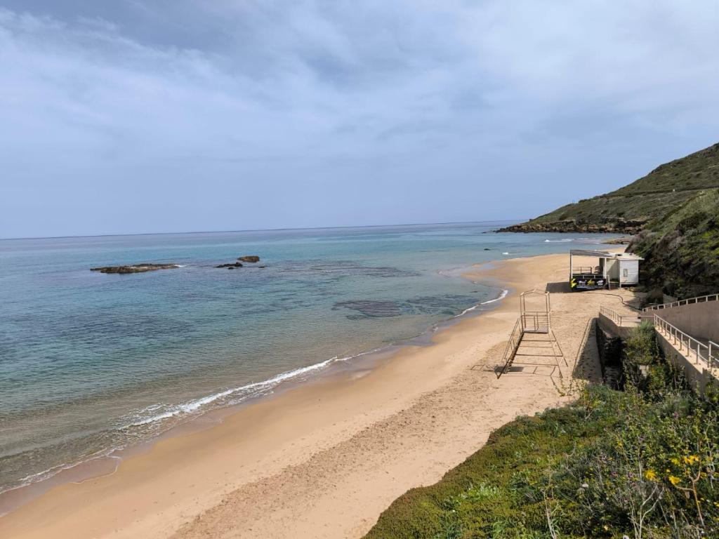a beach next to the ocean on a cliff at CASA PATTY in Castelsardo