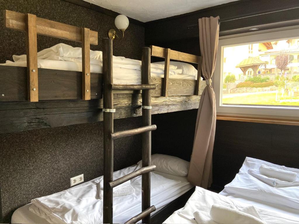 two bunk beds in a room with a window at Ferienwohnung Michel 02 im Haus Schwarzwaldmarille- Todtnauberg, Feldberg - b45630 in Todtnau