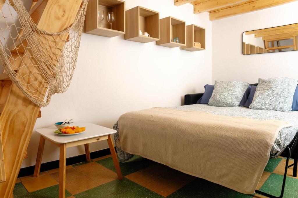 a bedroom with a bed and a side table at Las Velas in Las Palmas de Gran Canaria