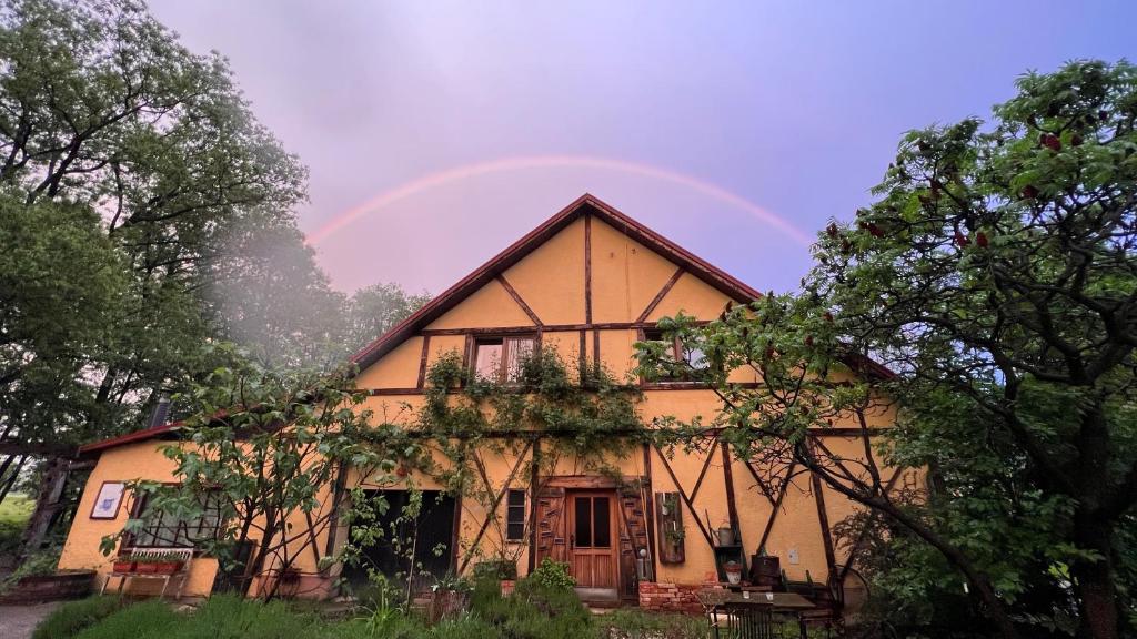 a rainbow in the sky above a house at Ranch Nana's House in Slovenske Konjice