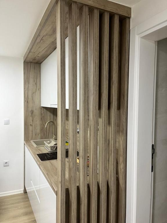 a kitchen with wooden walls and a counter at Apartment Irma in Sarajevo