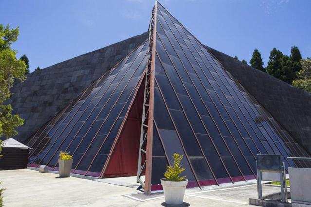a large building with a large glass pyramid at La villa de la Rivière du mât in Saint-André