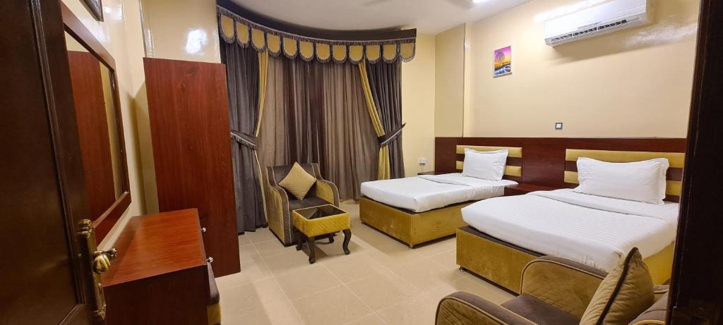 Postel nebo postele na pokoji v ubytování AL AMAN HOTEL