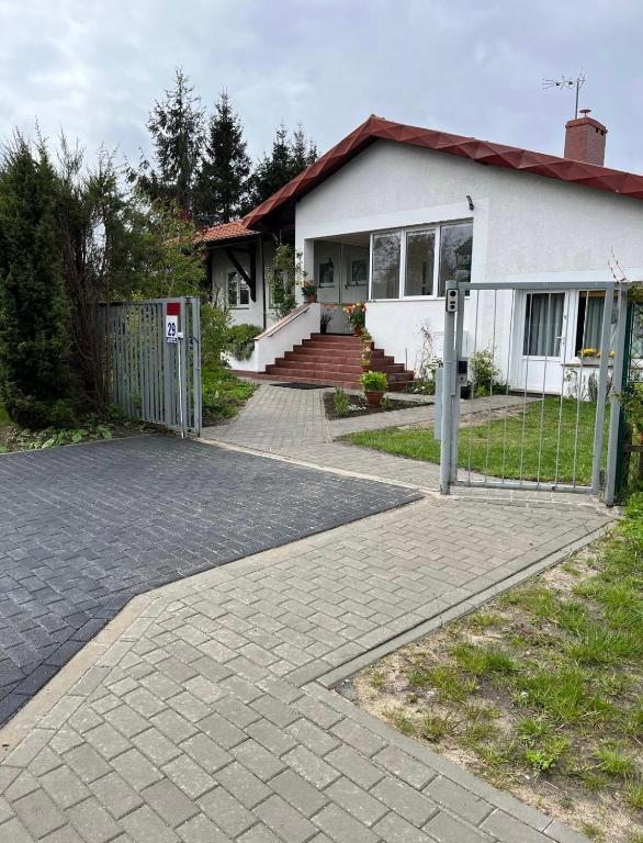 a house with a fence in front of it at Dom Natura in Grzybowo