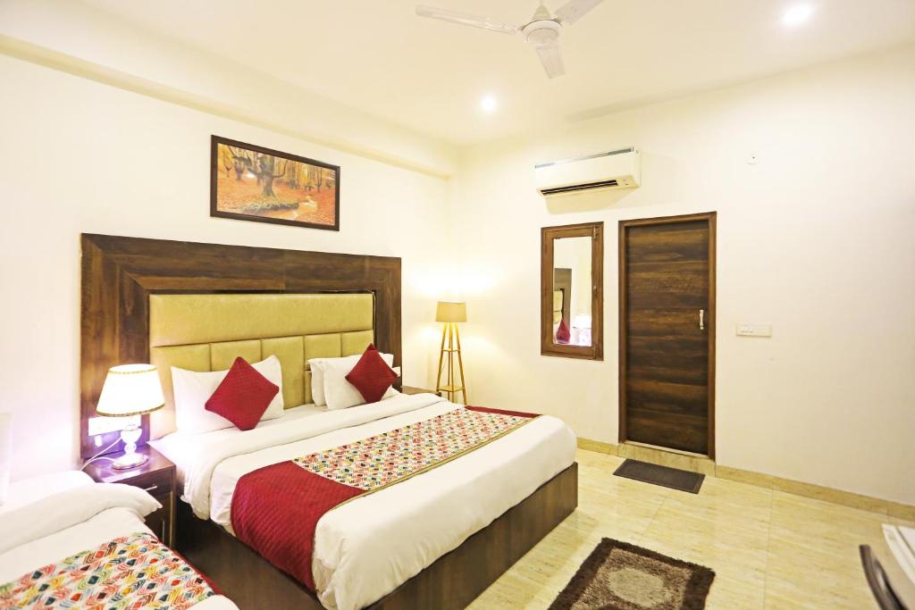 a hotel room with two beds in a room at Kiara-By Aashiyana Group Near Delhi Airport in New Delhi
