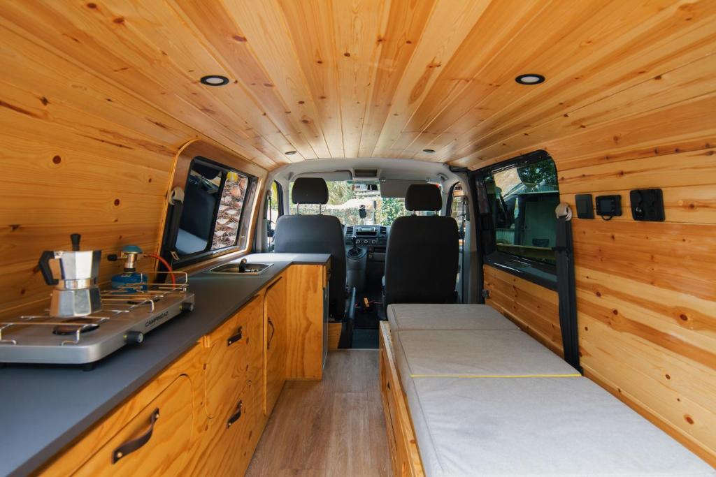 an interior view of an rv with wooden walls at Ibiza Camper Vans in Ibiza Town