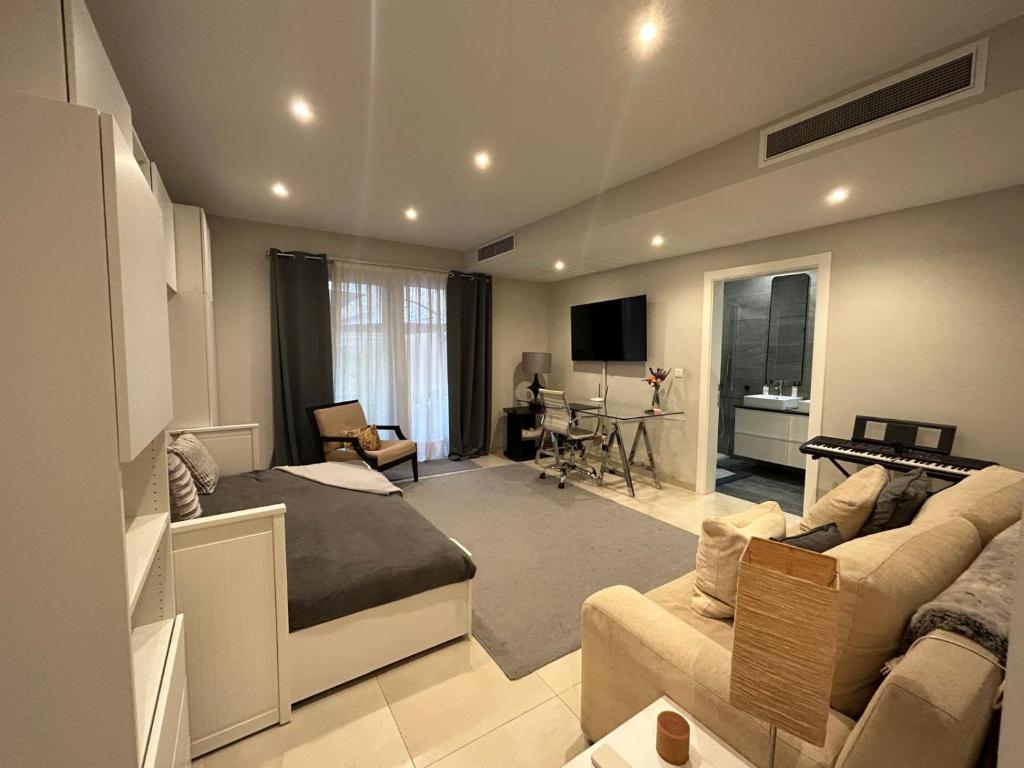 ein Schlafzimmer mit einem Bett und ein Wohnzimmer in der Unterkunft Spacious Luxury 3 bedroom apartment - Southridge - Mellieha in Mellieħa