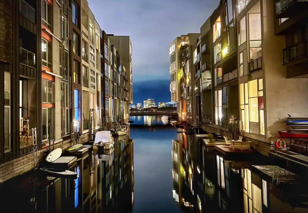 a group of buildings and a canal with boats at Canal view In City in Copenhagen
