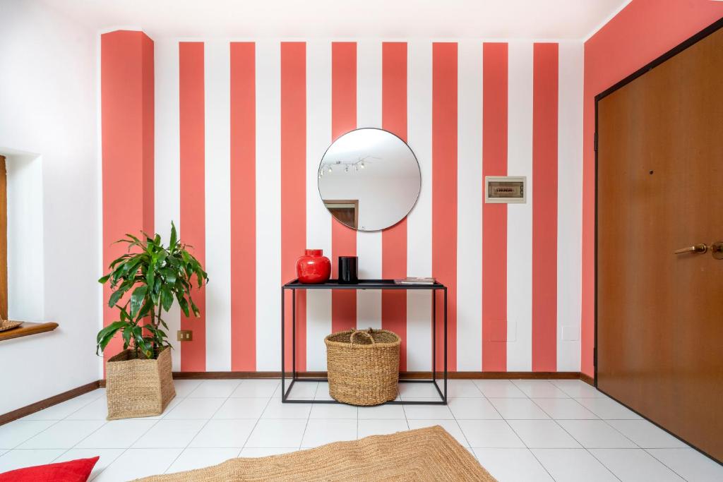 a room with a red and white striped wall at Le Mandarine Apartments - Superior Apartment in Udine
