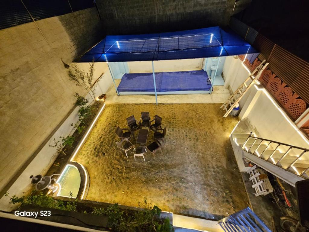 an overhead view of a patio with a table and chairs at SYED FAMILY REST HOUSE in Karachi