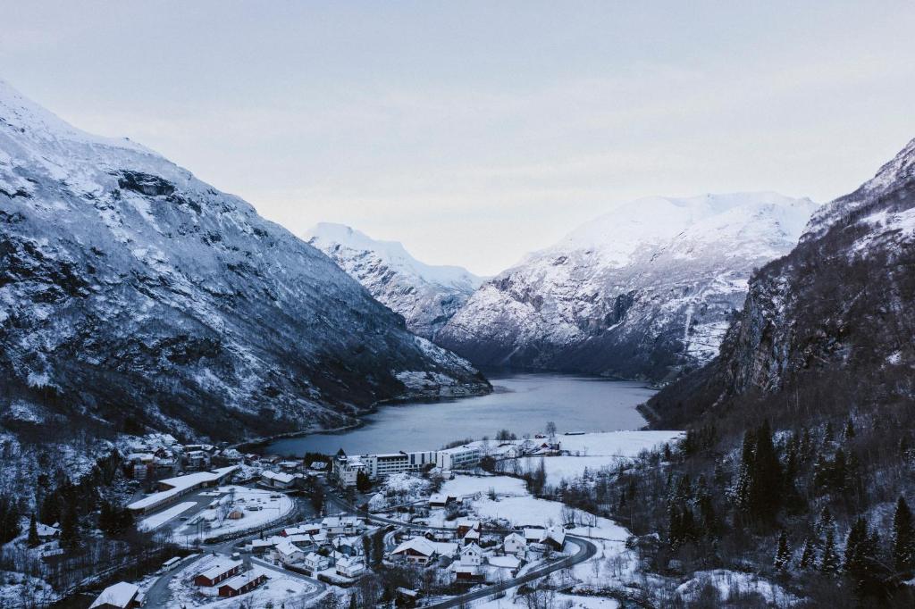 an aerial view of a village in a mountain valley at Vinje Camping in Geiranger