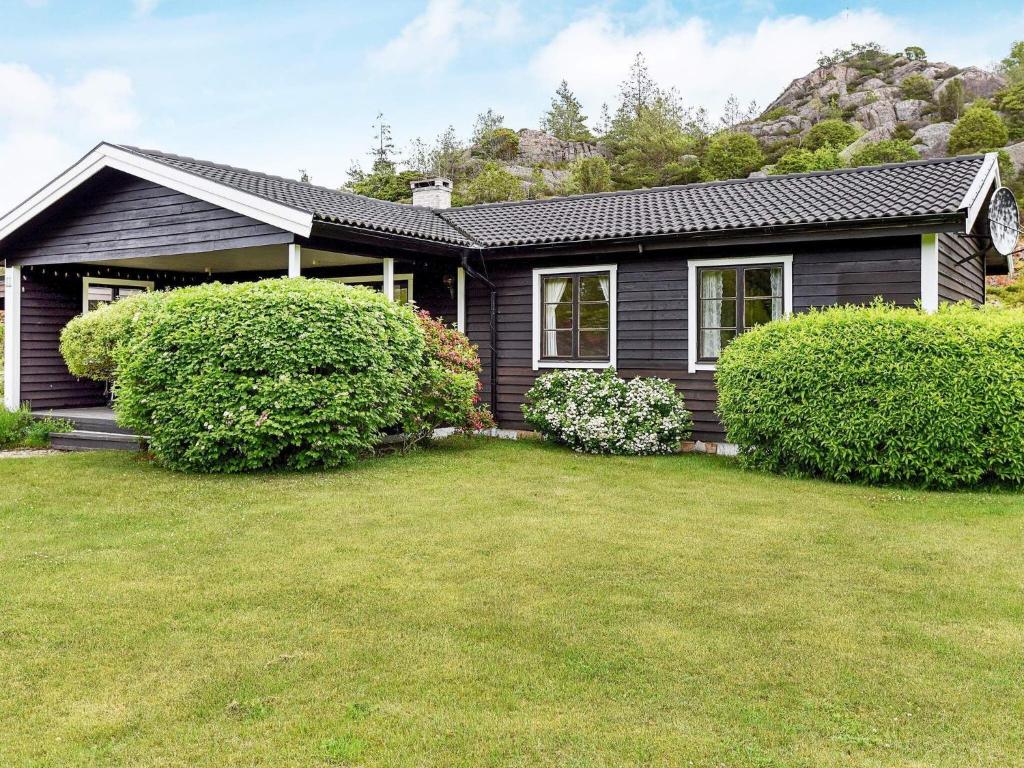 a house with a yard in front of it at 7 person holiday home in Bovallstrand in Bovallstrand