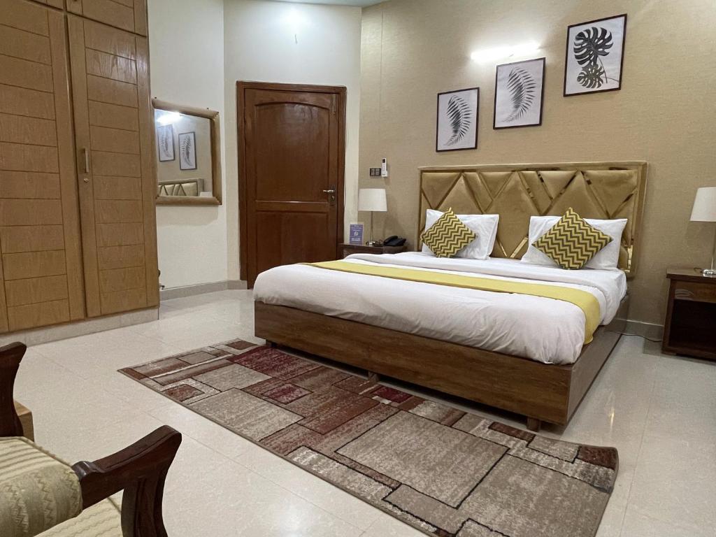 a bedroom with a large bed in a room at Safari Hotel in Islamabad