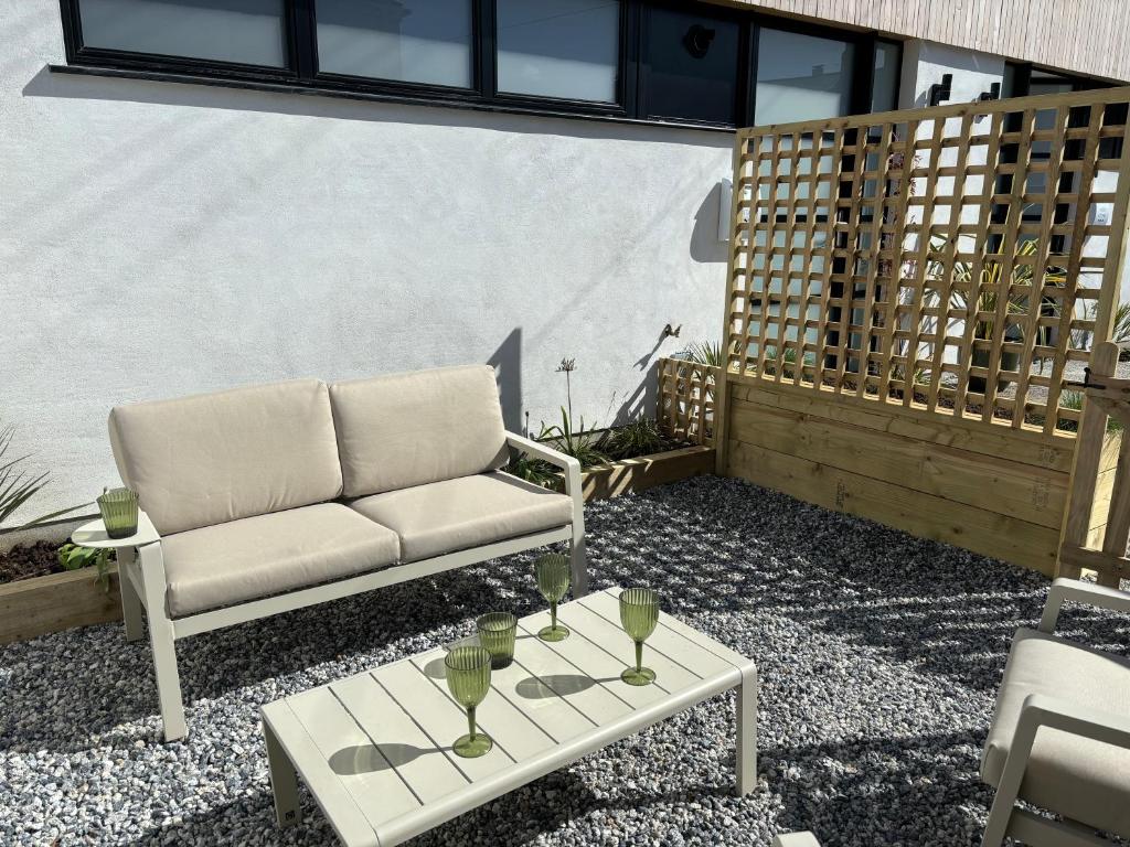 a couch and a coffee table on a patio at Coastal Retreat, Torquay - Anstey Cottage in Torquay