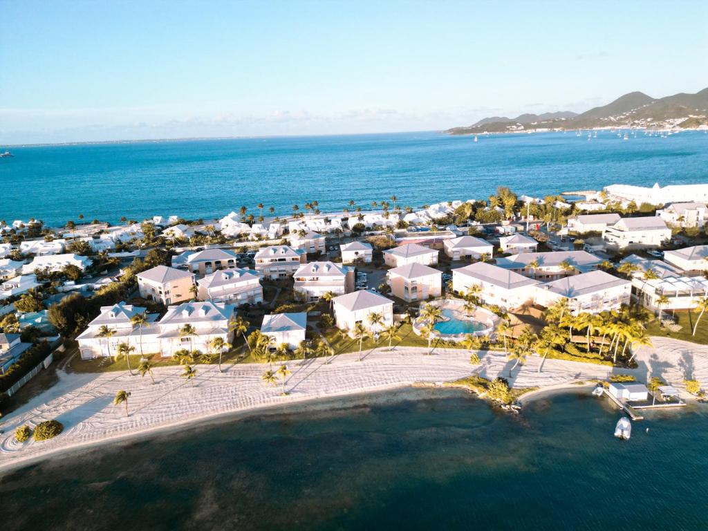 an aerial view of a resort next to the ocean at Condo Enjoy in Baie Nettle