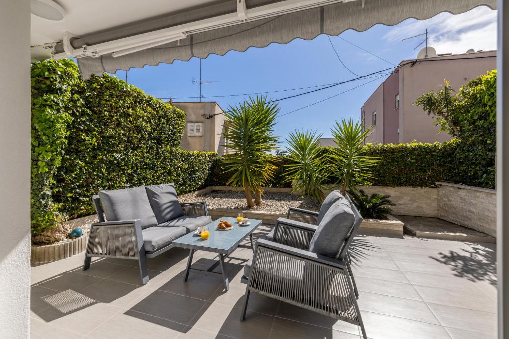 a patio with two chairs and a table on a patio at Luxury Apartment Anna in Split