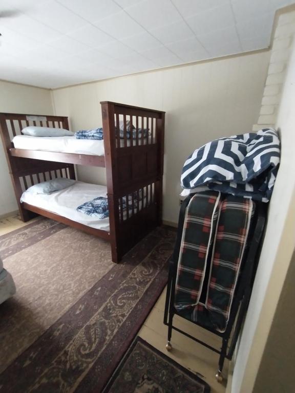 a room with two bunk beds in a room at Adirondack Retreat in Bakers Mills