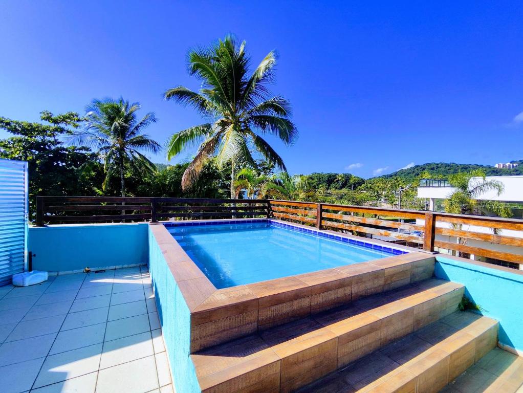 a swimming pool on the roof of a house at Pousada Sereia Tropical in Guarujá
